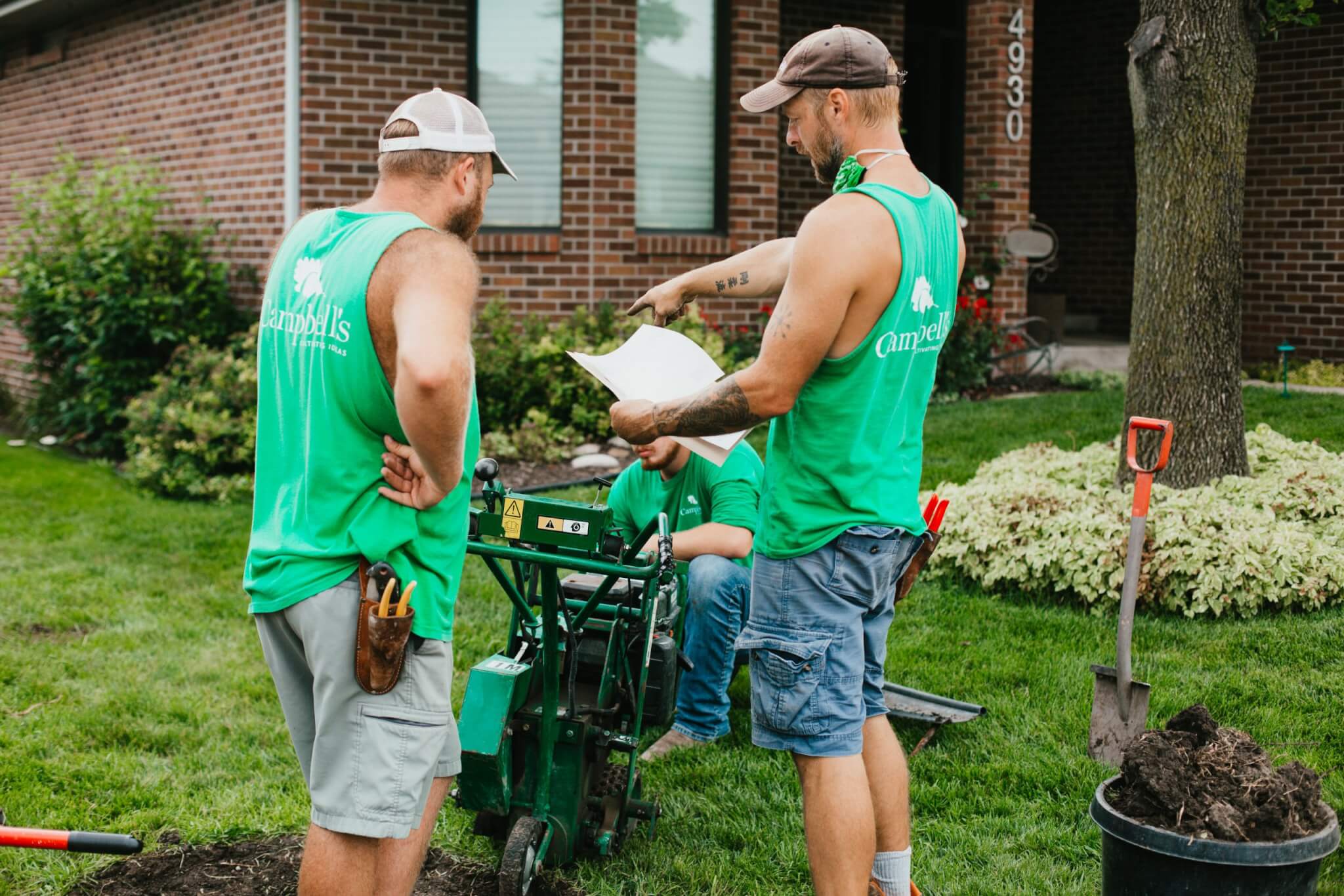 8X8A7316 The Campbell's landscaping crew hard at work planning out a job on site.